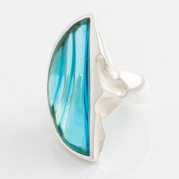 A Lapponia silver ring set with blue glass.