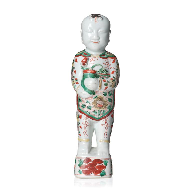 A wucai decorated porcelain figure of a laughing boy, 17th Century.