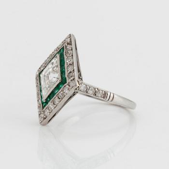 A RING set with diamonds and emeralds.