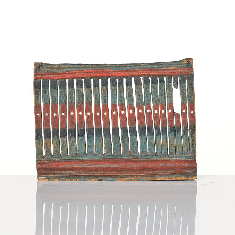 A Swedish carved and polychrome painted weaving tool from Hälsingland, 19th century.