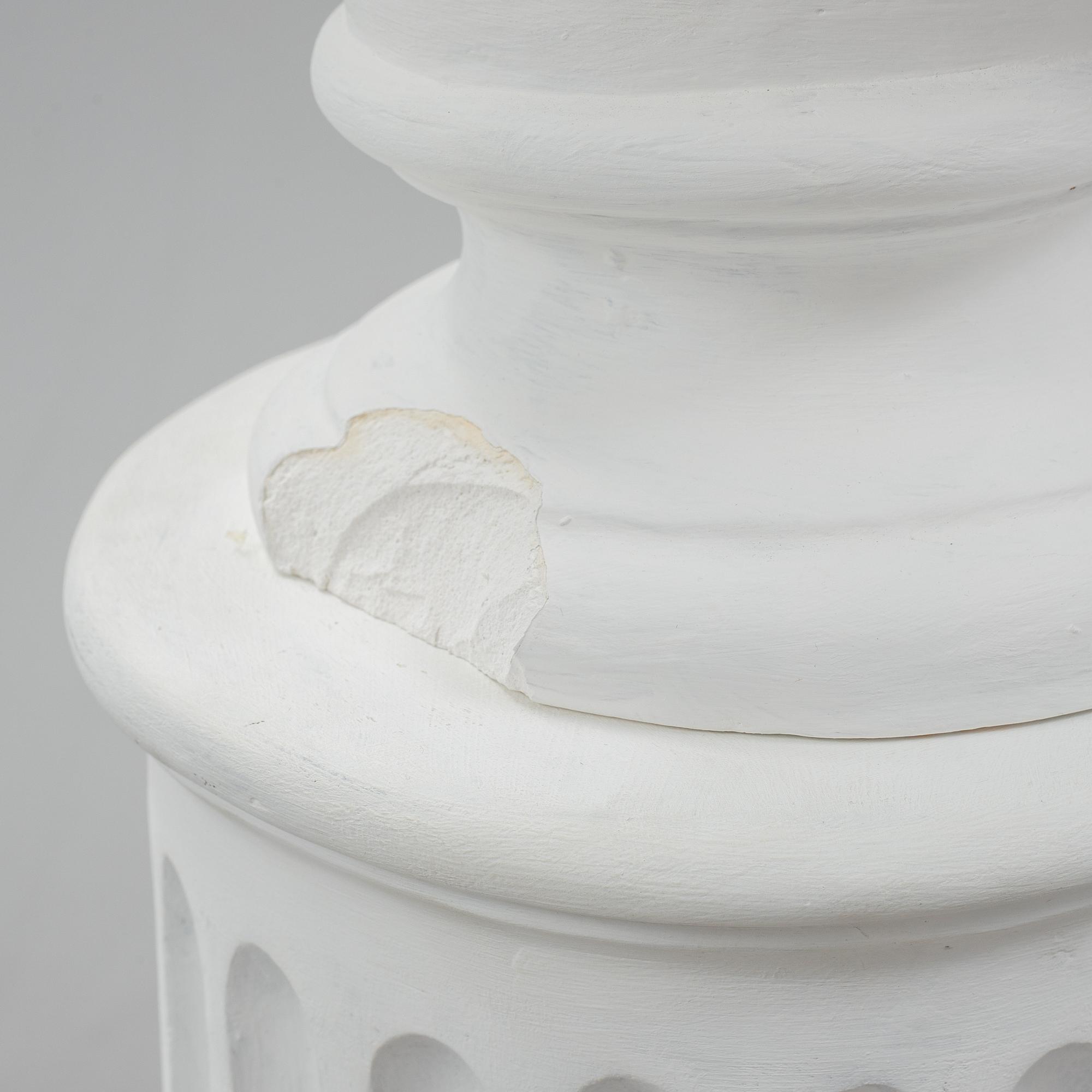 A plaster bust and pedestal.