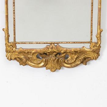 A gilt-gesso rococ-style mirror, 20th century.