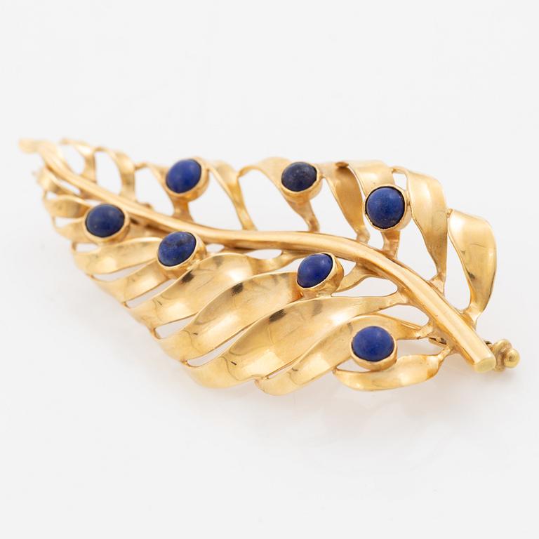 Brooch 18K gold with blue stones.
