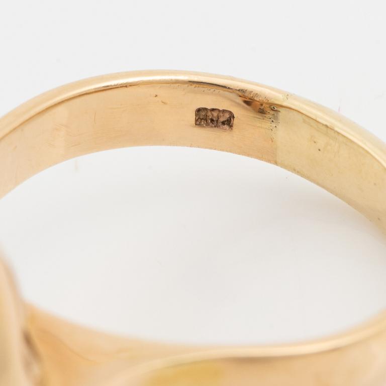 A 14 k gold ring set with a half pearl and round brilliant-cut diamonds.