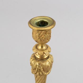 A pair of bronze Louis XV-style candlesticks, circa 1900.