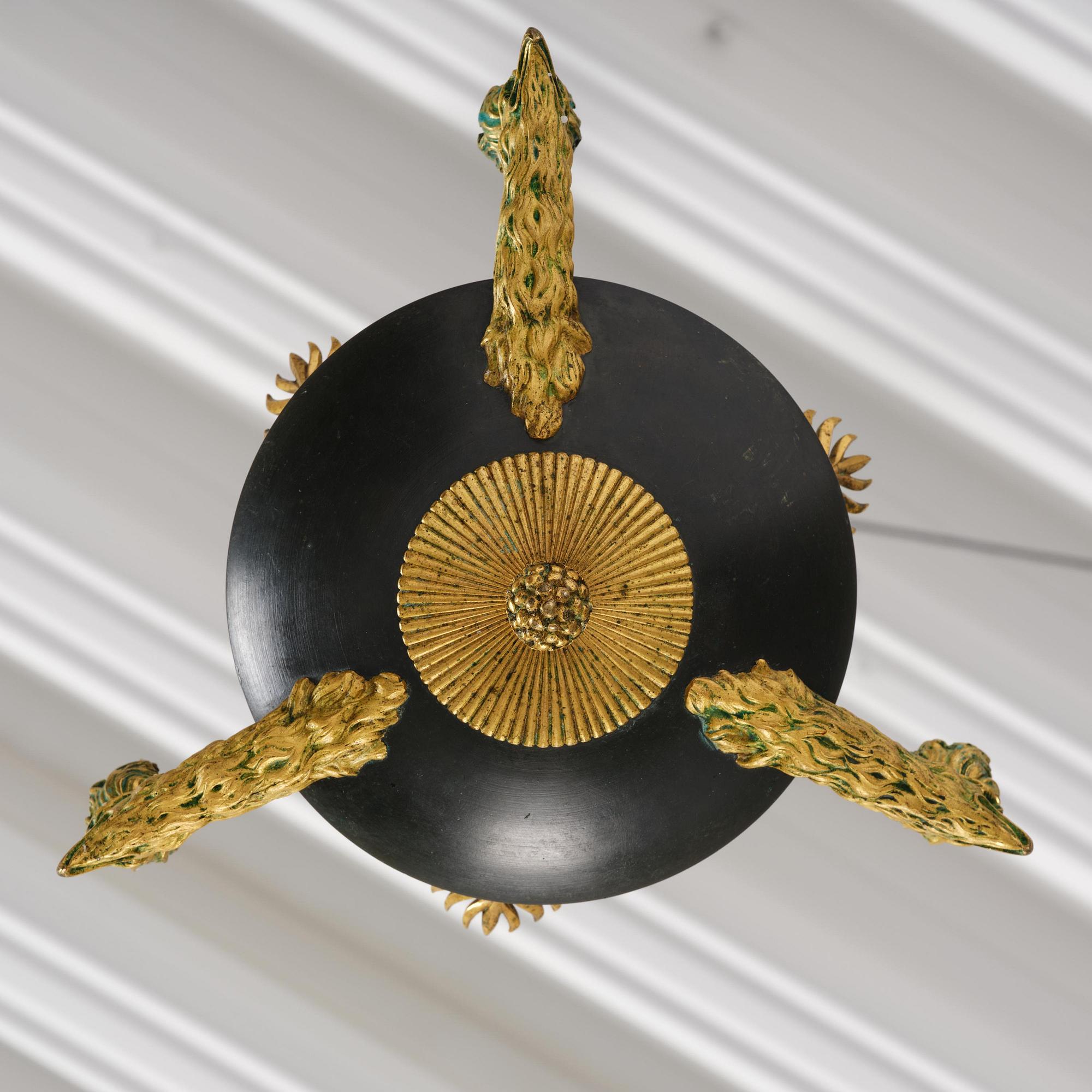 An Empire ormolu and patinated bronze four-light chandelier, Stockholm, early 19th century.
