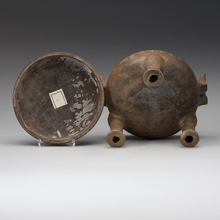 A pottery tripod censer, Han dynasty (206 B.C. -220 A.D.).