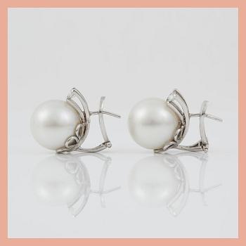 A pair of cultured South sea pearl and diamond earrings. Total carat weight of diamonds circa 0.35 ct.