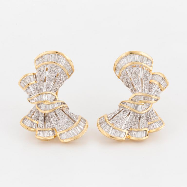 A pair of earrings in the shape of bows set with round, brilliant and tapered, baguette-cut diamonds.