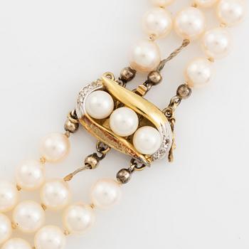 Three-row pearl necklace, cultured pearls, gold clasp with octagonal cut diamonds.