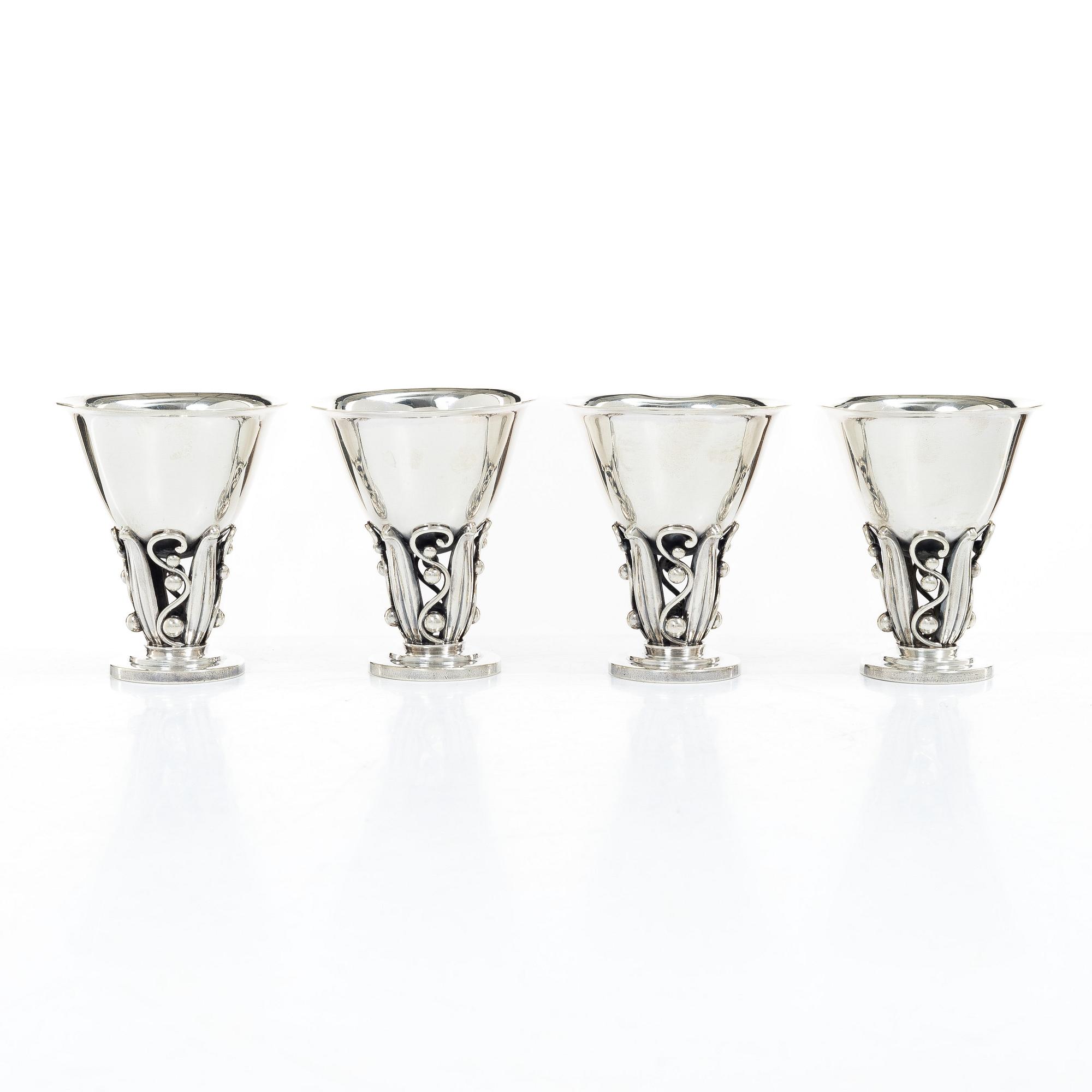 Evald Nielsen, four sterling silver beakers/cups on a foot, Denmark 20th century.