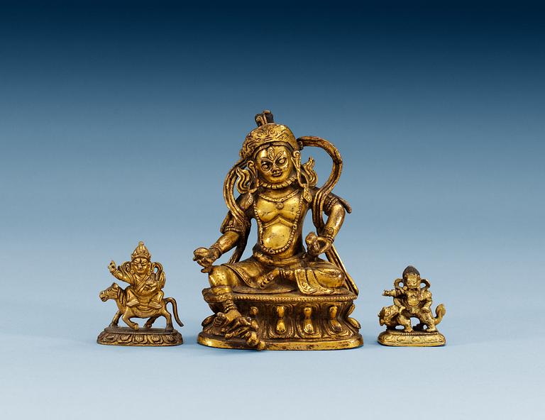 A set of three gilt bronze figures, one of Kuwera and two of Buddha, Qing dynasty, 18th/19th Century.