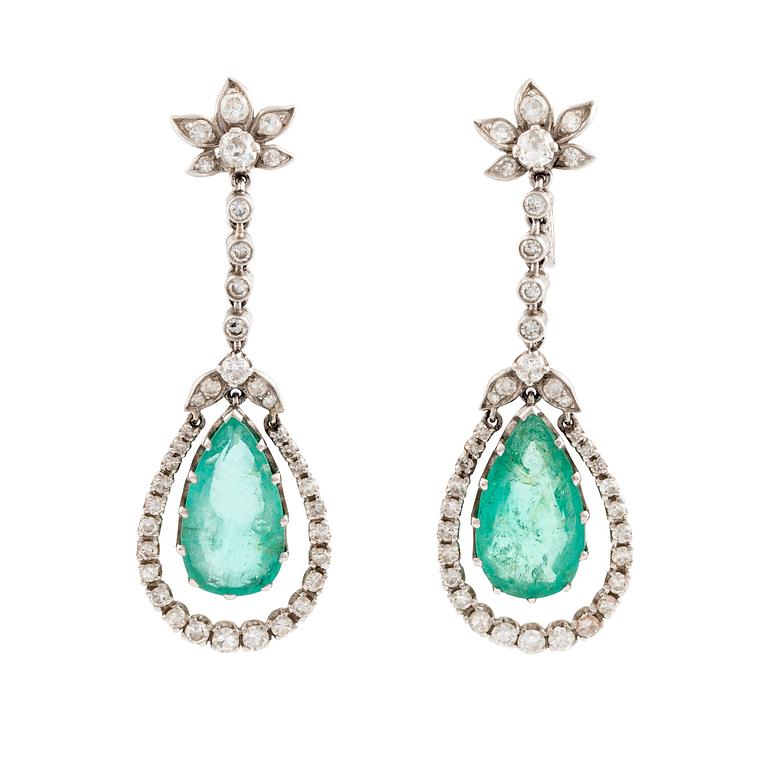 A pair of drop shaped emerald and diamond earrings.