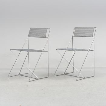 8 contemporary stackable metal chairs.