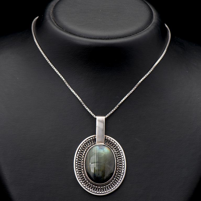 A SAARA HOPEA PENDANT, cabochon cut spectrolite, silver. Ossian Hopea, Porvoo Finland 1976.