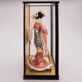 A latter half of the 20th century Japanese doll in showcase.