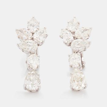 A pair of 18K white gold earrings set with round and oval brilliant-cut diamonds.