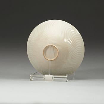 A white glazed bowl with incised pattern of flower-scrolls, Qing Dynasty, 18th Century.