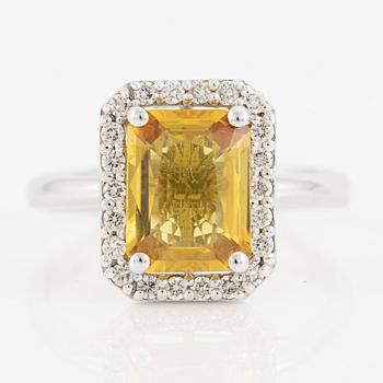 Ring in 18K gold with a faceted sapphire and round brilliant-cut diamonds.