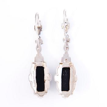 Four Art deco jewelry, ring, pendant necklace and earrings in silver.