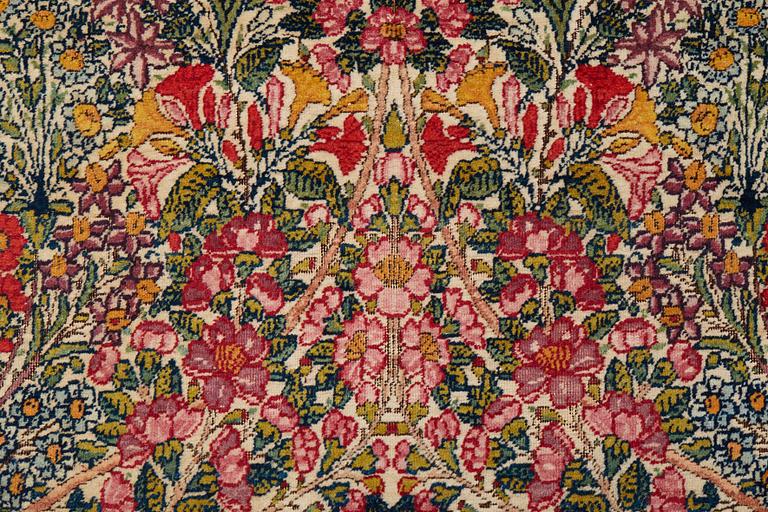 A RUG, a semi-antique Kerman "mille-fleur", ca 198,5 x 136,5 cm.