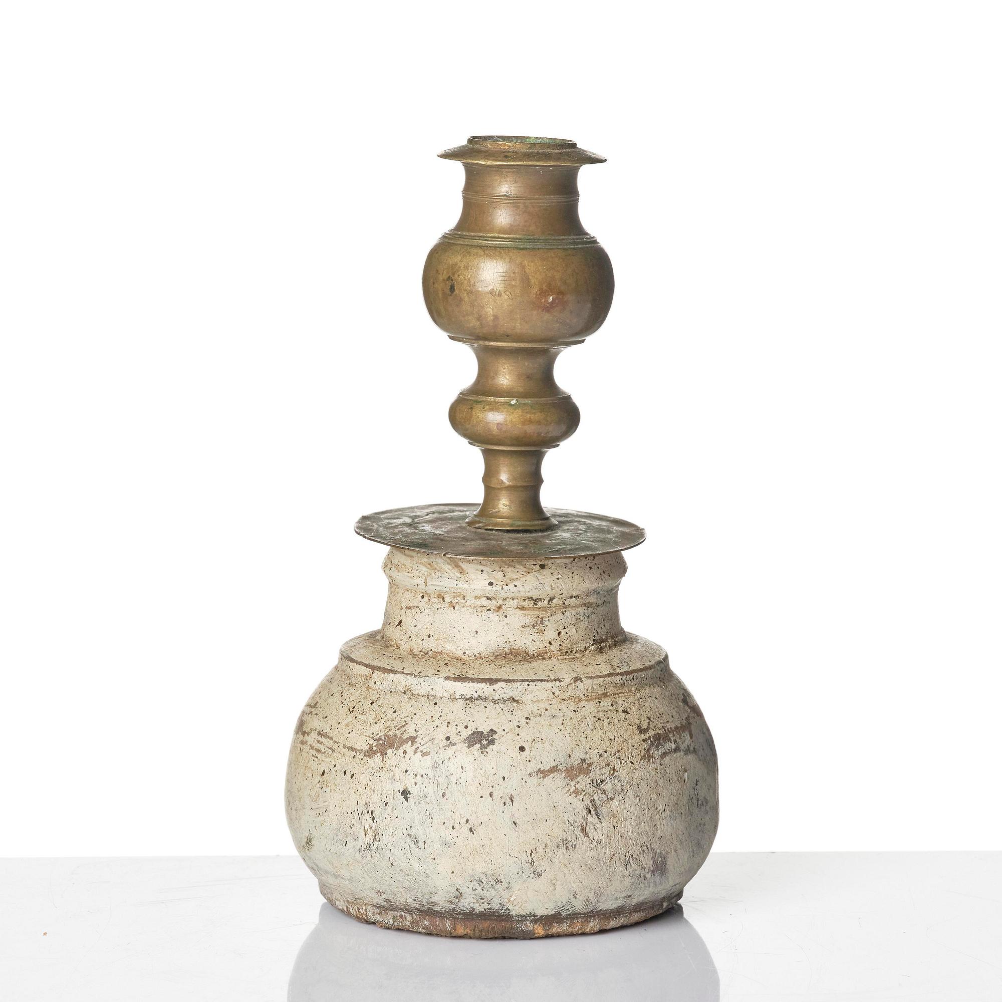 A Northern European baroque candlesticks, late 17th century, with a repaired wooden base.