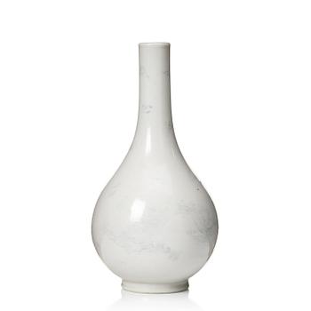 640. A white glazed anhua decorated vase, 18th Century.