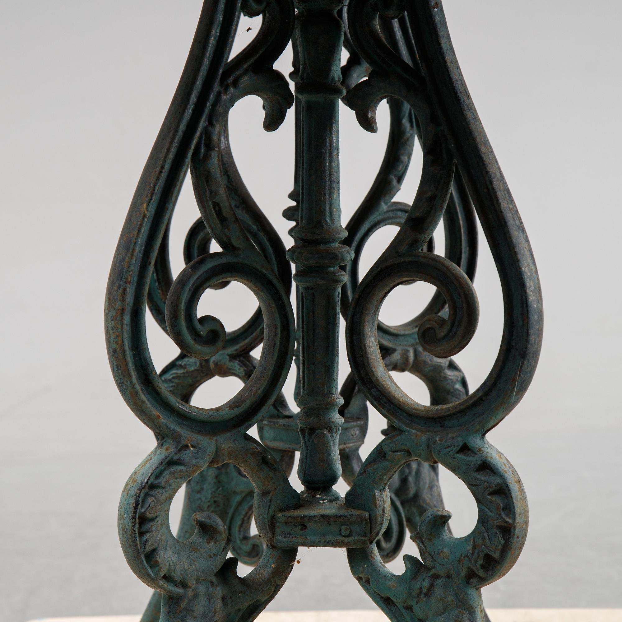 A early 20th Century cast iron garden table with later concrete top.