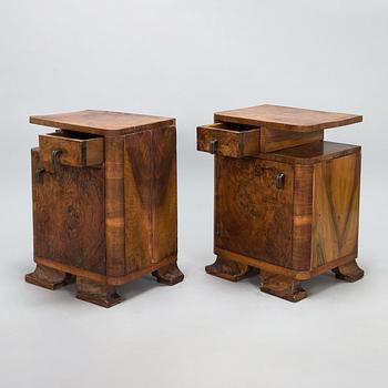 A pair of around 1930s bedside tables.