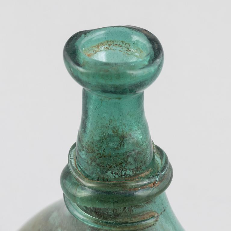 A turquoise tinted glass bottle, 19th century.