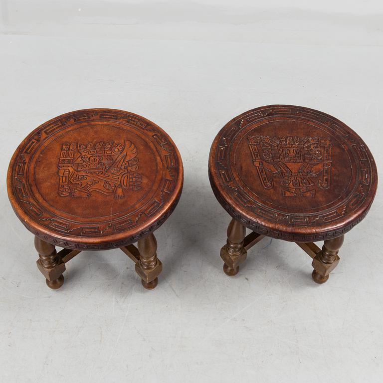 A Peruvian leather covered coffee table and pair of stools, second half of the 20th Century.