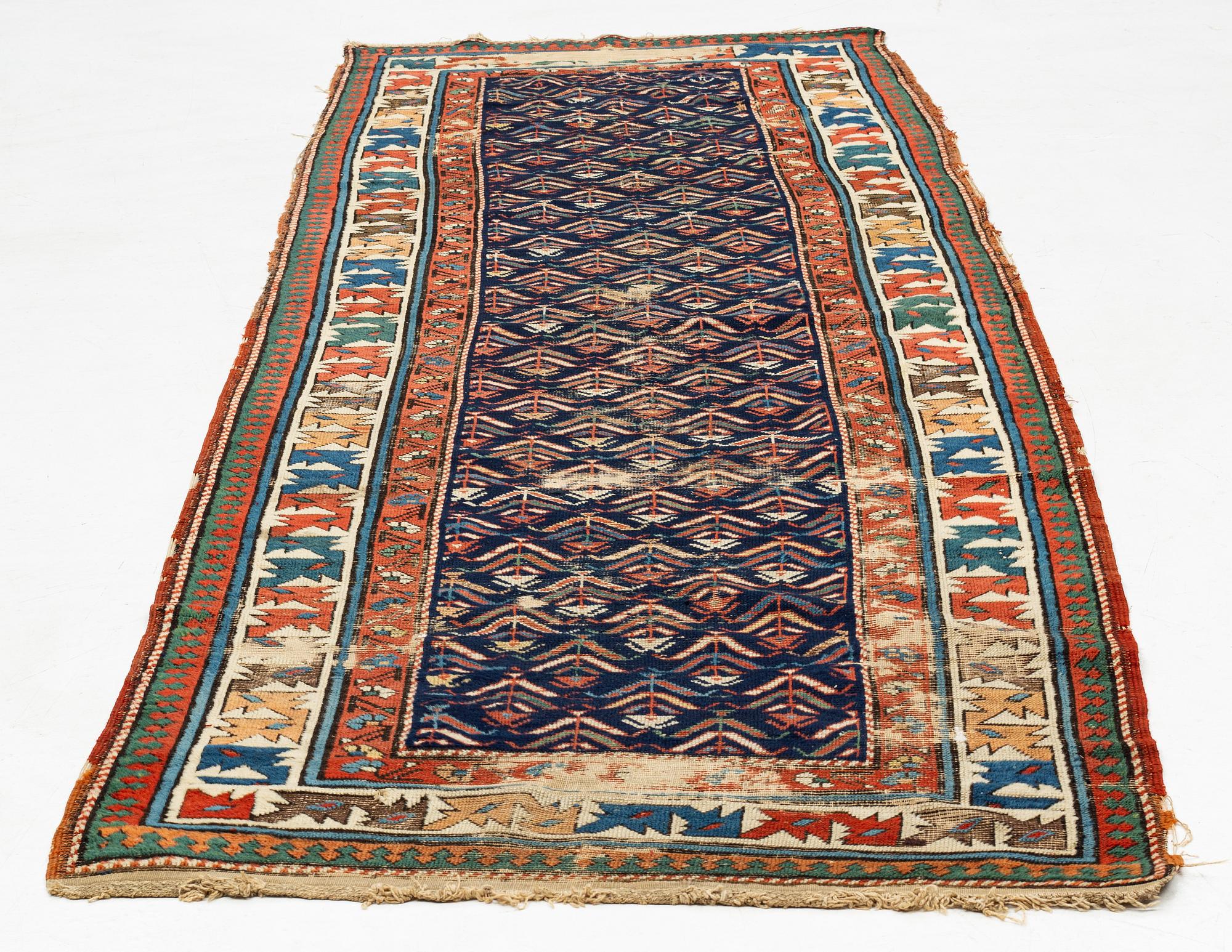 A antique Kazak gallery carpet, ca 310 x 105 cm.