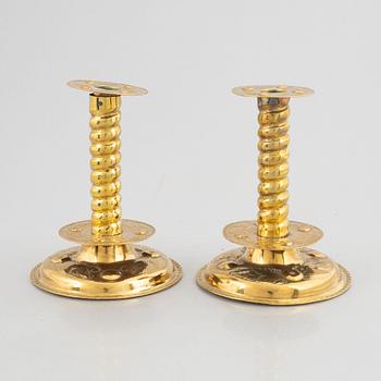 A pair of brass baroque style candlesticks, end of the 19th century.