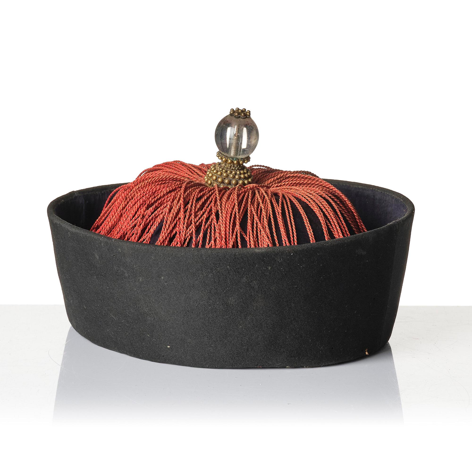 Two boxes with a mandarin's summer hat and black satin autumn hat and feather with six mandarin hat insignias.