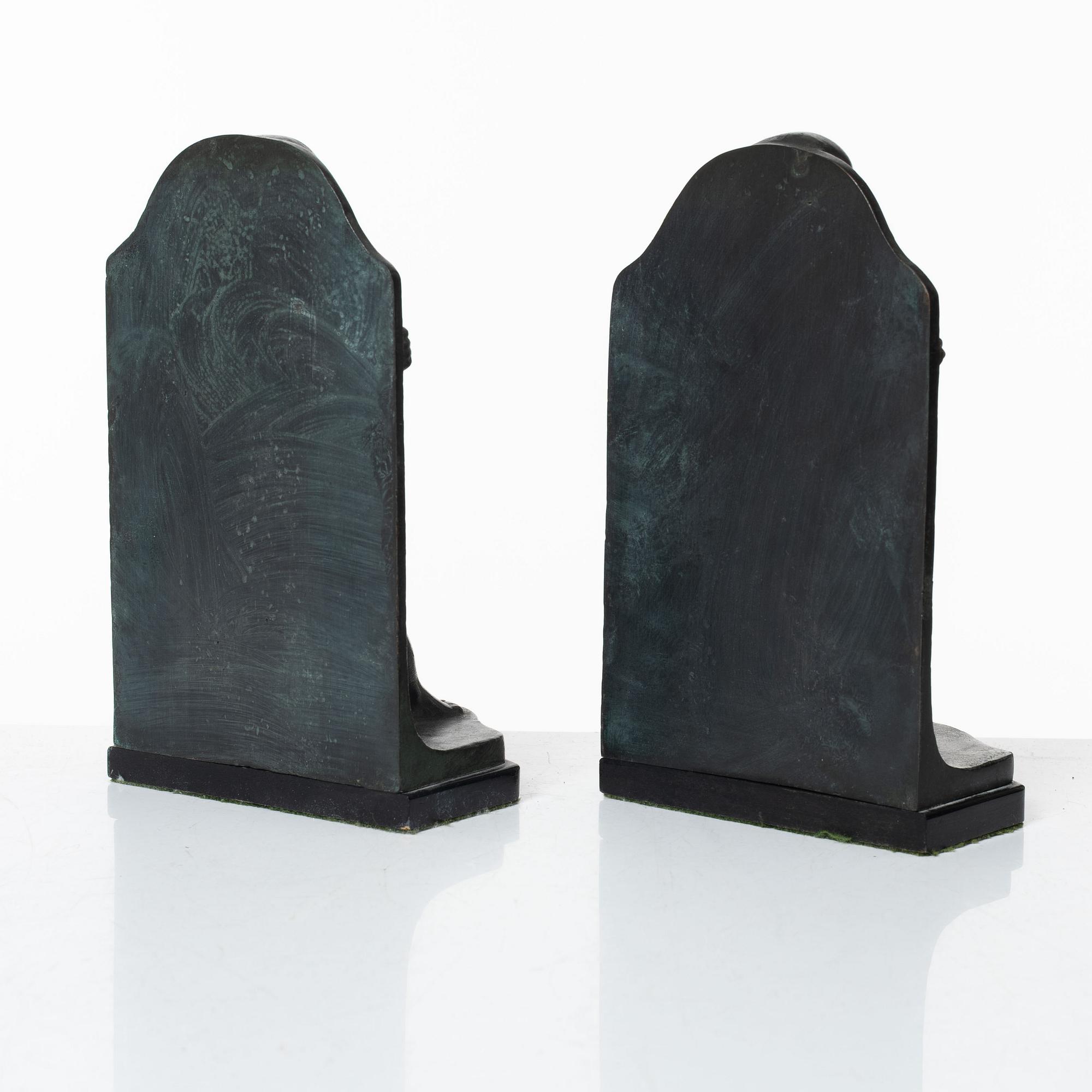 Axel Gute, a pair of patinated bronze bookends, dated 1920.