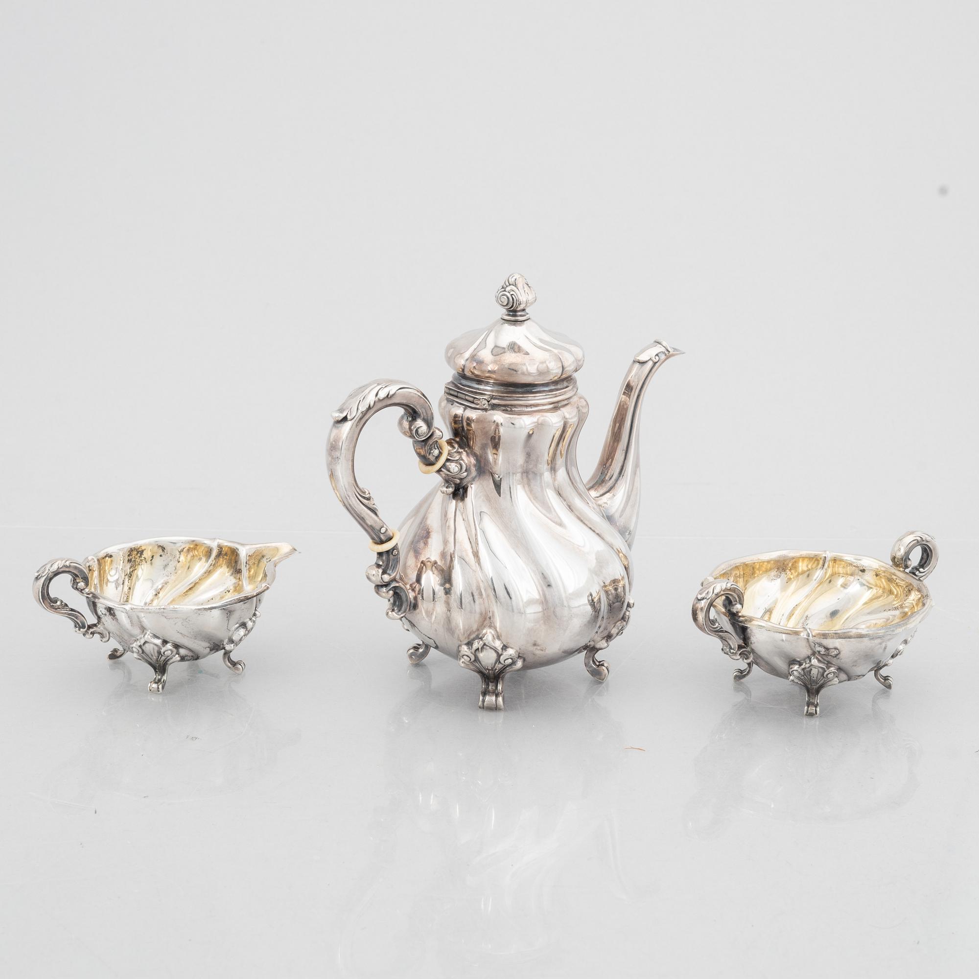 A Rococo Style Silver Coffee Pot, Creamer and Sugar Bowl, 20th Century, Swedish import mark.