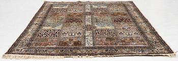 An oriental silk carpet, c. 305 x 205 cm.