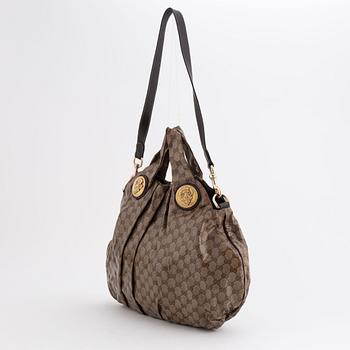 Gucci, a canvas handbag.
