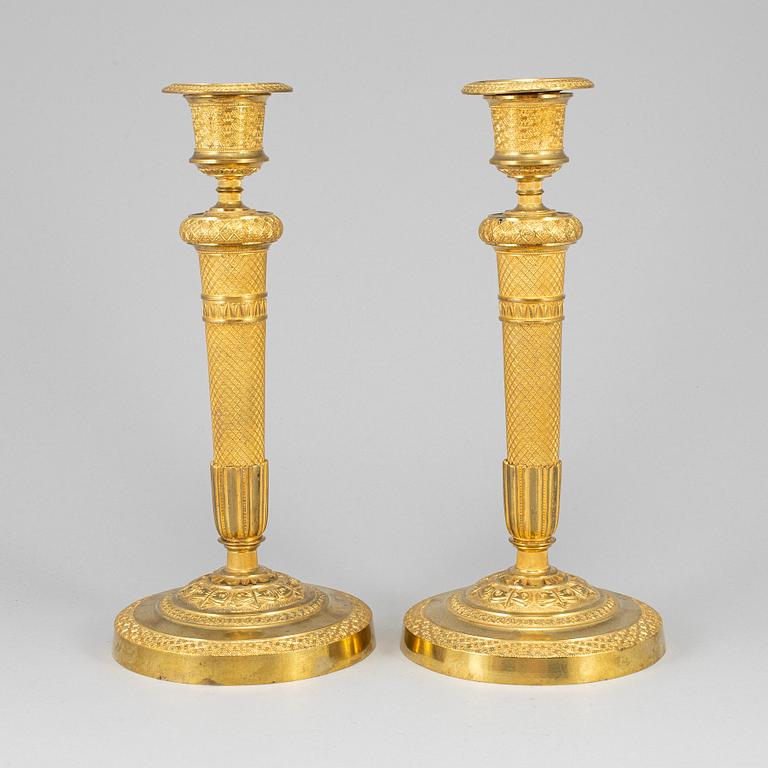 A pair of ormolu candlesticks, first half of the 19th century.