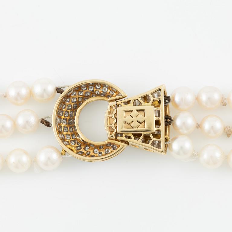 Pearl necklace, three strands of cultured pearls, clasp in gold set with baguette and brilliant-cut diamonds.