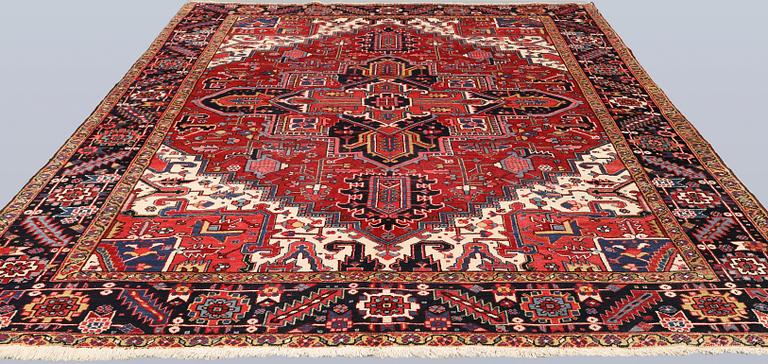 A semi-antique Heris carpet, approx. 343 x 260 cm.