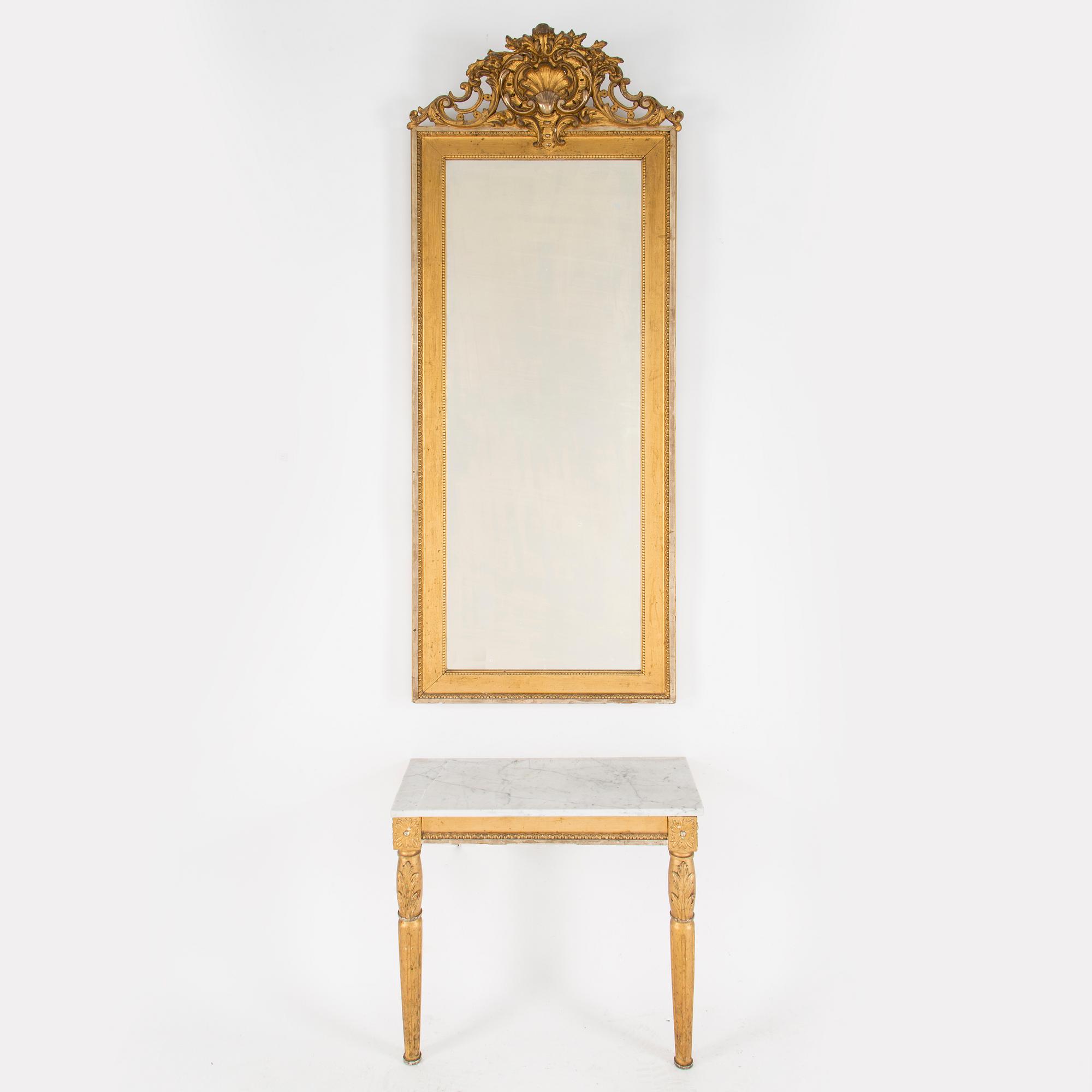 A Swedish Gustavian style mirror and console table with marble top from the first half of the 20th century.