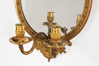 A pair of French Louis XIV-style ormolu two-light girandoles, after a model by Daniel Marot (1661-1752).