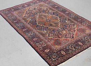 A rug, semi-antique Kashan, ca 216,5 x 140 cm.