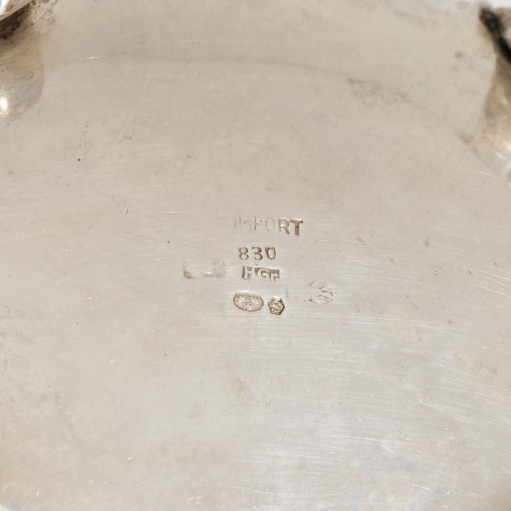 A Rococo style silver coffee pot, cream jug and sugar bowl, 20th century, Swedish import mark.
