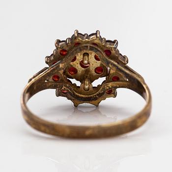 A ring, earrings and a necklace made of gilded silver and garnets.