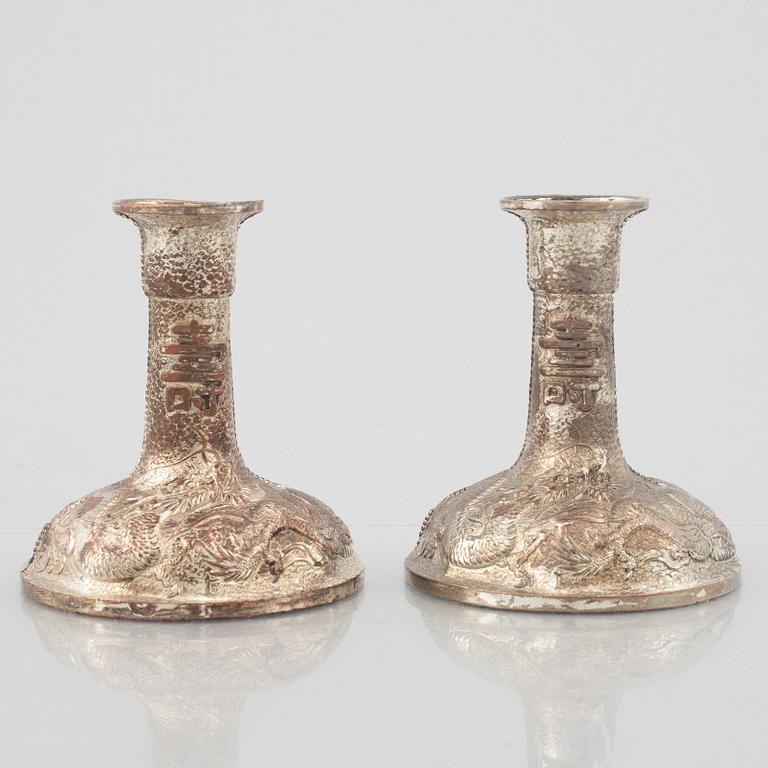 A pair of Chinese silver plated copper candle sticks, 20th century.