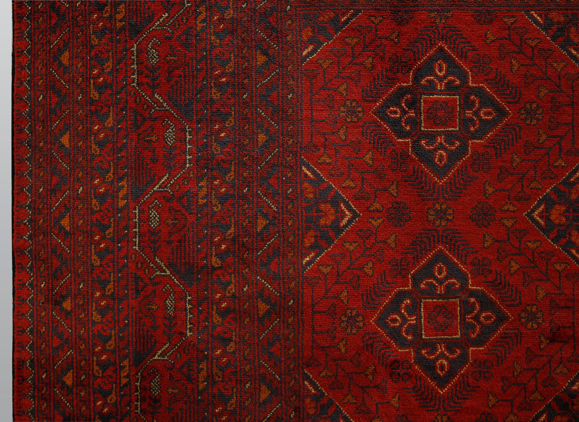 An Afghan carpet, 343 x 243 cm.