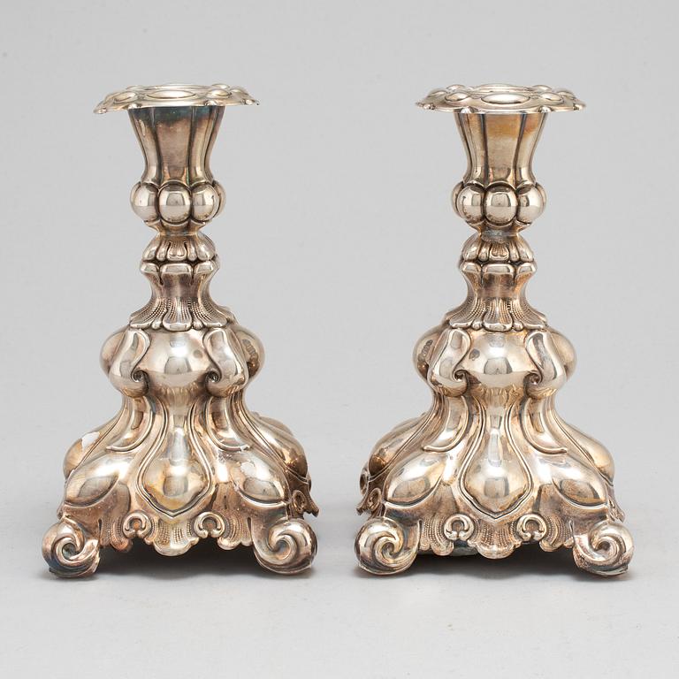 A pair of silver candle sticks.-.