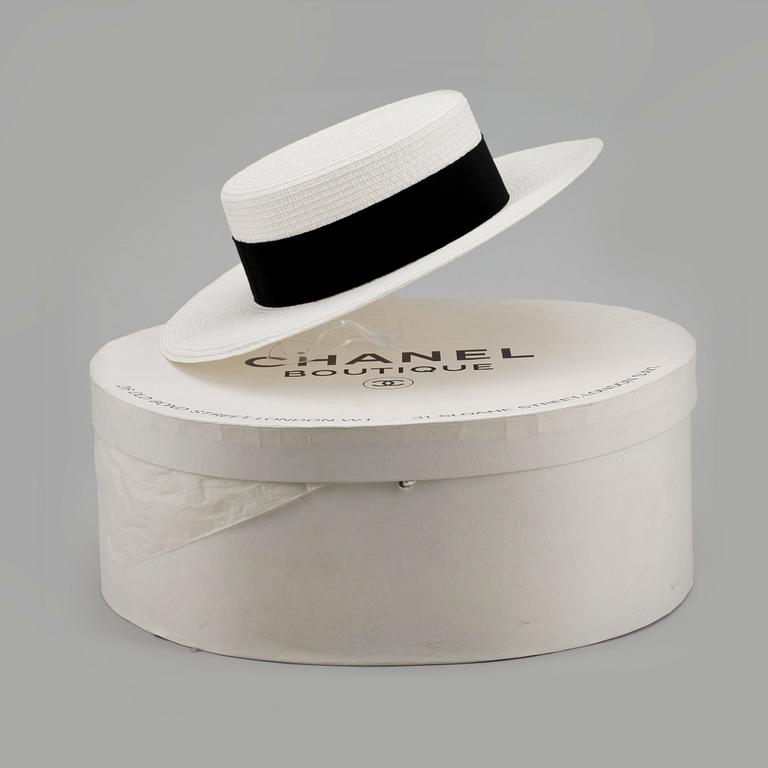 CHANEL, a white straw hat.